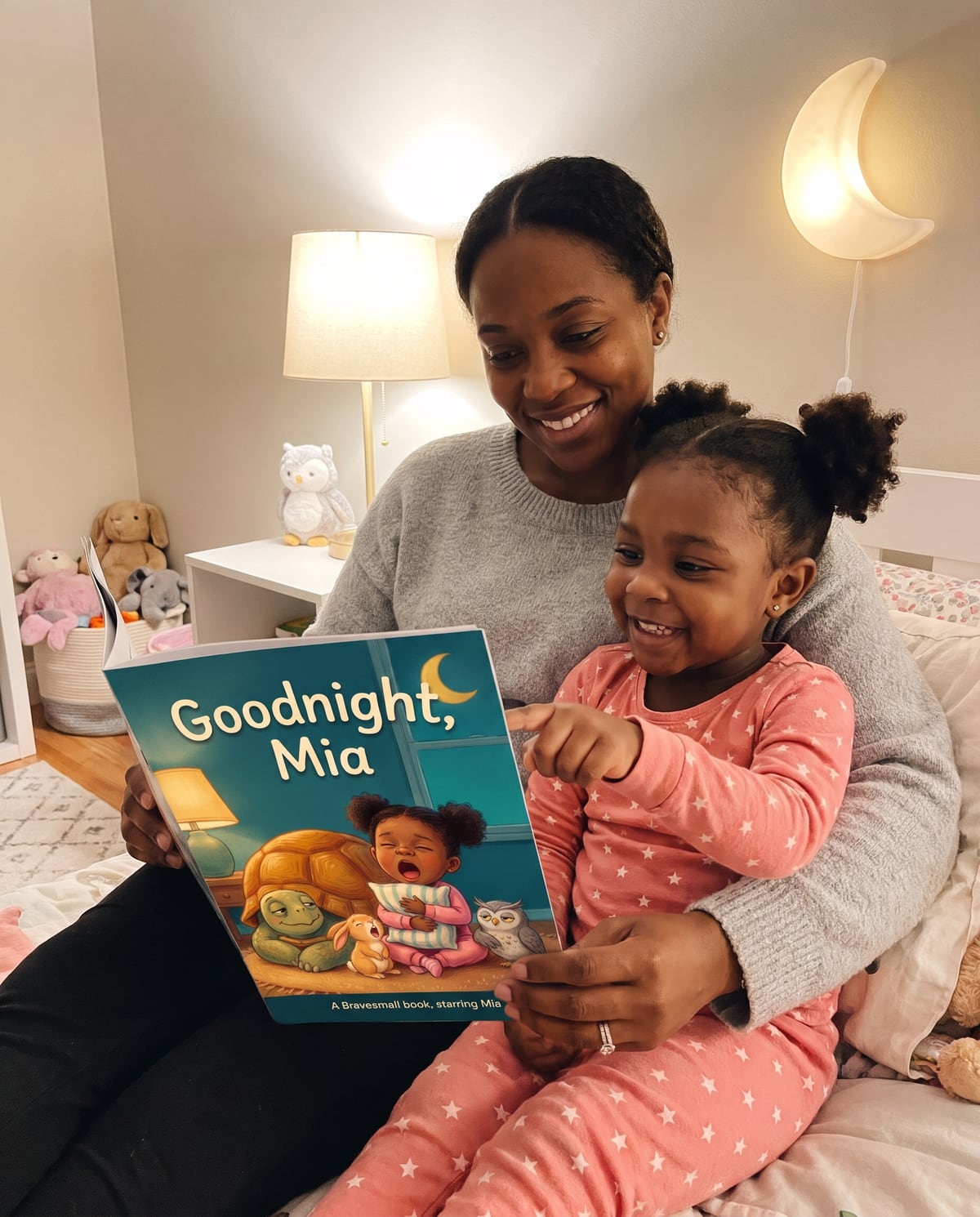 A mother and daughter on a bed reading Goodnight, Mia